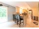 Open-concept kitchen with a breakfast bar, granite countertops, and stainless steel appliances at 2875 Prairie Stream Way, Columbus, IN 47203