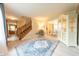 Open living space with hardwood floors, staircase, and a view of the dining room and kitchen at 2875 Prairie Stream Way, Columbus, IN 47203