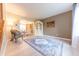Spacious living room with elegant furnishings, hardwood floors, and an open connection to the dining area at 2875 Prairie Stream Way, Columbus, IN 47203