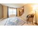 Bright living room with hardwood floors, a large window, and a comfortable seating area at 2875 Prairie Stream Way, Columbus, IN 47203