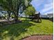 Expansive backyard featuring mature trees, lush landscaping, a patio area, and a playground at 319 Mcintosh Ln, Westfield, IN 46074