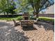 Outdoor patio area featuring brick pavers, fireplace, and outdoor seating and manicured landscaping at 319 Mcintosh Ln, Westfield, IN 46074