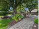 Outdoor patio area featuring brick pavers, lush landscaping, outdoor kitchen and dining at 319 Mcintosh Ln, Westfield, IN 46074