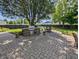 Outdoor patio area featuring brick pavers, built-in outdoor kitchen, dining area and manicured lawn at 319 Mcintosh Ln, Westfield, IN 46074