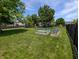 Large backyard featuring grass lawn, mature trees, playground, and garden plots at 319 Mcintosh Ln, Westfield, IN 46074