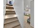 Basement stairs lead to a cozy seating area with carpeted floors at 319 Mcintosh Ln, Westfield, IN 46074
