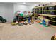 Neutral carpeted basement featuring storage shelves and a selection of toys at 319 Mcintosh Ln, Westfield, IN 46074