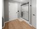 Bright bathroom features wood floors and a glass enclosed shower with tile accents at 319 Mcintosh Ln, Westfield, IN 46074