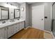 Bathroom with double sink vanity, granite countertops, wood flooring, and tiled shower at 319 Mcintosh Ln, Westfield, IN 46074