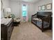 Bedroom with carpet flooring, a crib, dresser, and rocking chair at 319 Mcintosh Ln, Westfield, IN 46074