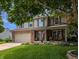 Charming two-story home featuring a well-manicured lawn, front porch and attached two car garage at 319 Mcintosh Ln, Westfield, IN 46074
