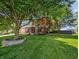 Expansive front yard featuring mature trees and manicured landscaping at this two-story home at 319 Mcintosh Ln, Westfield, IN 46074