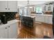 Bright kitchen featuring an island with seating, white cabinets, and modern backsplash at 319 Mcintosh Ln, Westfield, IN 46074