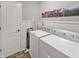 Functional laundry room with a washer, dryer, and ample space at 319 Mcintosh Ln, Westfield, IN 46074