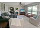 Comfortable living room with a fireplace, neutral decor, large windows and ceiling fan at 319 Mcintosh Ln, Westfield, IN 46074