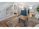 Inviting living room with staircase, cabinet, wood floors, and open layout to kitchen at 319 Mcintosh Ln, Westfield, IN 46074