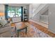 Cozy living room with large window, staircase, wooden floors, and stylish decor at 319 Mcintosh Ln, Westfield, IN 46074