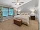 Neutral main bedroom with a ceiling fan, two bedside lamps, a bed and a large window at 319 Mcintosh Ln, Westfield, IN 46074