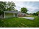 This backyard offers a covered patio space, brick exterior, and gravel area perfect for outdoor enjoyment at 3457 W 58Th St, Indianapolis, IN 46228