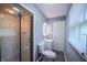 Modern bathroom with shower featuring marble-look tile and a sleek glass door at 3457 W 58Th St, Indianapolis, IN 46228