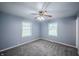 Cozy bedroom with plush carpet, neutral walls, and ample natural light from two windows at 3457 W 58Th St, Indianapolis, IN 46228