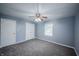 Neutral bedroom with plush carpet, ceiling fan, closet, and ample natural light from one window at 3457 W 58Th St, Indianapolis, IN 46228