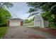 The property features a detached white shed and attached garage with an extended driveway at 3457 W 58Th St, Indianapolis, IN 46228