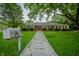 Charming brick home with stone walkway surrounded by lush green grass at 3457 W 58Th St, Indianapolis, IN 46228