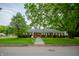 Quaint single-story brick home with a stone pathway and mature shade trees in the front yard at 3457 W 58Th St, Indianapolis, IN 46228