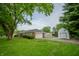 Charming brick ranch-style home featuring an attached garage and well-maintained front yard with mature tree at 3457 W 58Th St, Indianapolis, IN 46228