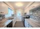 Recently remodeled kitchen featuring stainless steel appliances, mosaic backsplash, and new vinyl flooring at 3457 W 58Th St, Indianapolis, IN 46228
