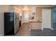 Modern kitchen featuring white cabinets, stainless steel appliances, and luxury vinyl flooring at 3457 W 58Th St, Indianapolis, IN 46228