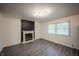 Bright living room featuring a brick fireplace and modern light fixture at 3457 W 58Th St, Indianapolis, IN 46228