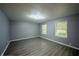 A bright room showcasing sleek gray walls, new vinyl floors, and modern lighting at 3457 W 58Th St, Indianapolis, IN 46228