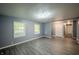 A well lit room featuring gray walls, modern lighting, and luxury vinyl flooring at 3457 W 58Th St, Indianapolis, IN 46228
