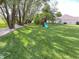 Playground with slide and swing set in spacious, grassy backyard at 425 Bridgewater S Ln, Muncie, IN 47304
