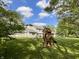 Spacious backyard featuring a playground, swing set, and lush green grass at 425 Bridgewater S Ln, Muncie, IN 47304