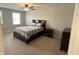 Bedroom features a queen bed, ceiling fan, and windows for natural light at 425 Bridgewater S Ln, Muncie, IN 47304