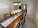 Dining room with a wooden table, seating for six, and an attractive floral display at 425 Bridgewater S Ln, Muncie, IN 47304