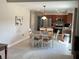 Dining room with a wooden table and seating for six adjacent to the open kitchen at 425 Bridgewater S Ln, Muncie, IN 47304