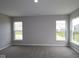 Spacious carpeted bedroom with three large windows offering natural light at 4250 Ironclad Dr, Bargersville, IN 46106