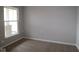 This bedroom has neutral walls with tan carpet and a window for natural light at 4250 Ironclad Dr, Bargersville, IN 46106