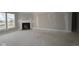Spacious living room with modern fireplace and large windows, providing warmth and natural light at 4250 Ironclad Dr, Bargersville, IN 46106