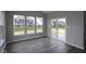 Sun-filled room with sliding glass door and plank flooring at 4250 Ironclad Dr, Bargersville, IN 46106