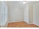 Neutral bedroom with parquet floor, bright window, and white door at 4337 English Ave, Indianapolis, IN 46201
