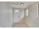 Bright foyer features a white door with a glass window, light tile flooring, and fresh paint at 4337 English Ave, Indianapolis, IN 46201