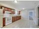 Functional kitchen with wooden cabinets and a bright white appliance suite at 4337 English Ave, Indianapolis, IN 46201
