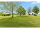 Lush green backyard with mature trees and a charming shed, perfect for outdoor enjoyment at 4450 N St Rd 39, Danville, IN 46122