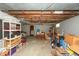 Unfinished basement with exposed ceiling, storage shelving, and concrete floor at 4450 N St Rd 39, Danville, IN 46122