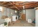 Unfinished basement area with washer, dryer, utility sink, and concrete floor at 4450 N St Rd 39, Danville, IN 46122